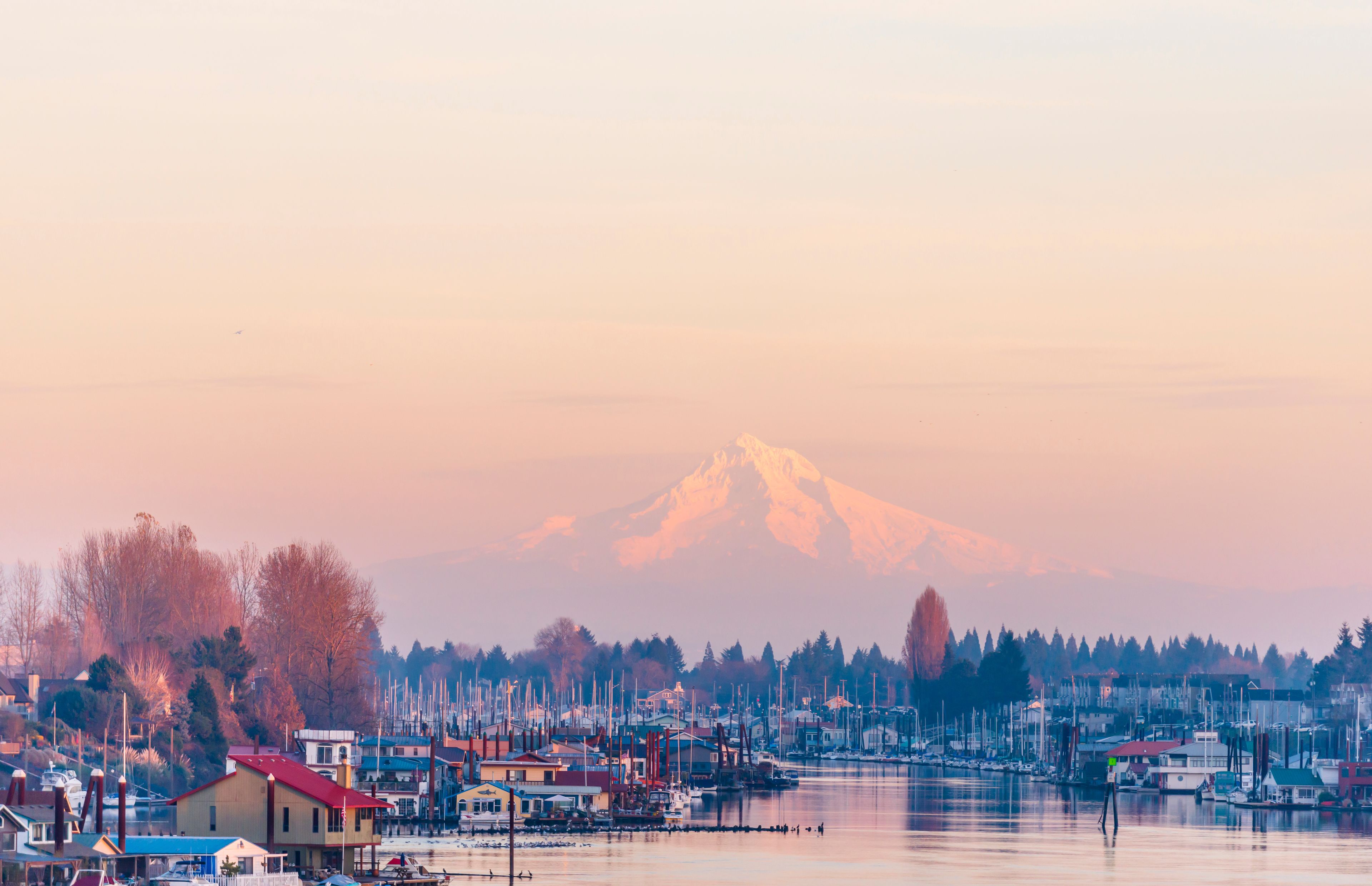 Evening view of the Columbia River with floating houses and boats and yachts moored at the berths on the background of the mountain Mount Hood