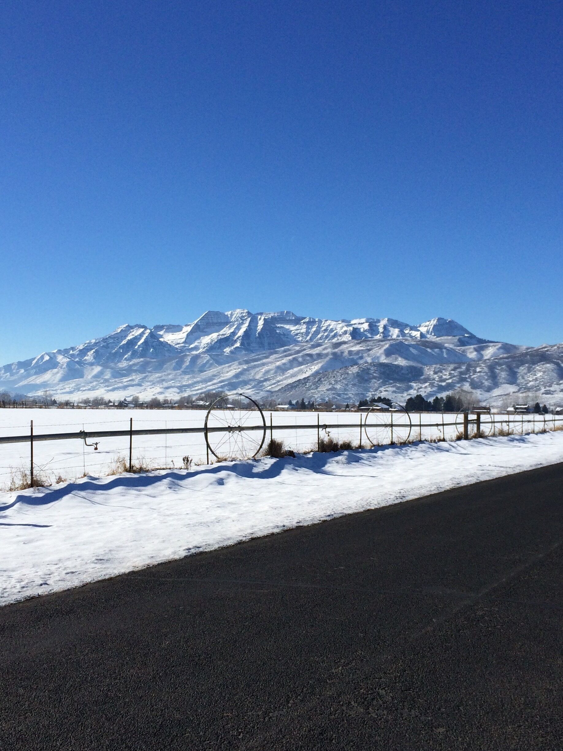 A snow-covered mountain range with a clear blue sky.