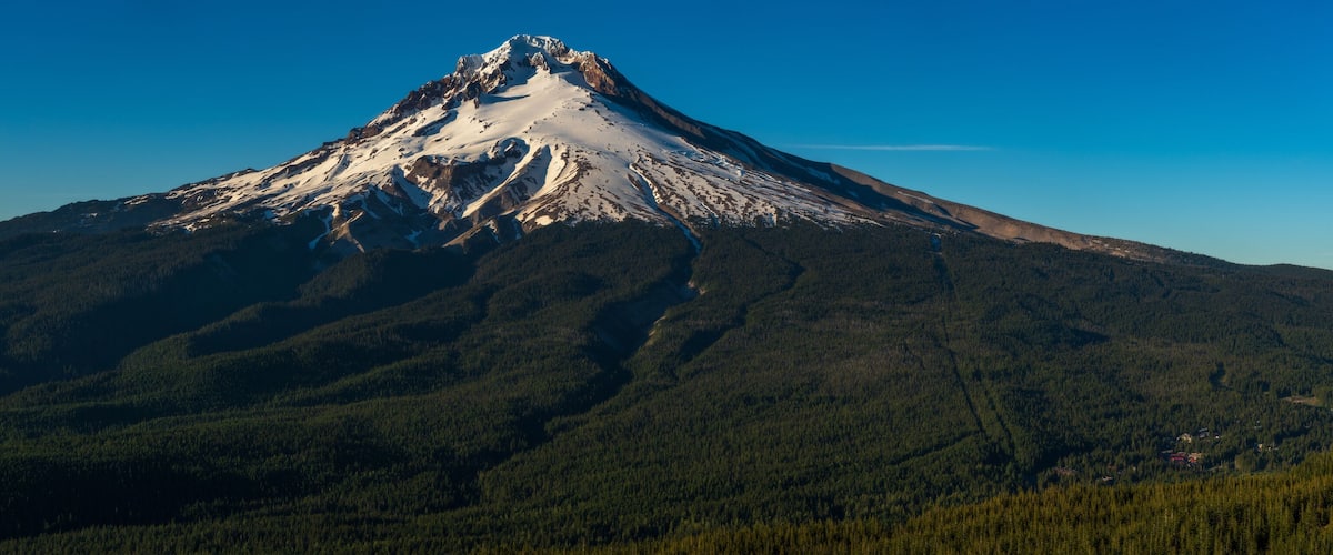 A snow-capped mountain with a clear sky.