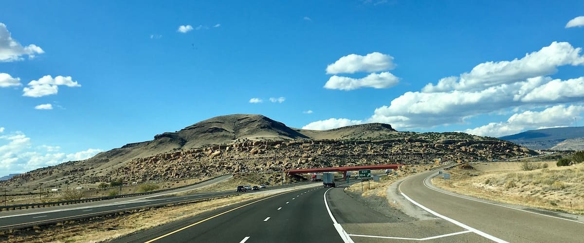 A highway with a mountainous landscape in the background.