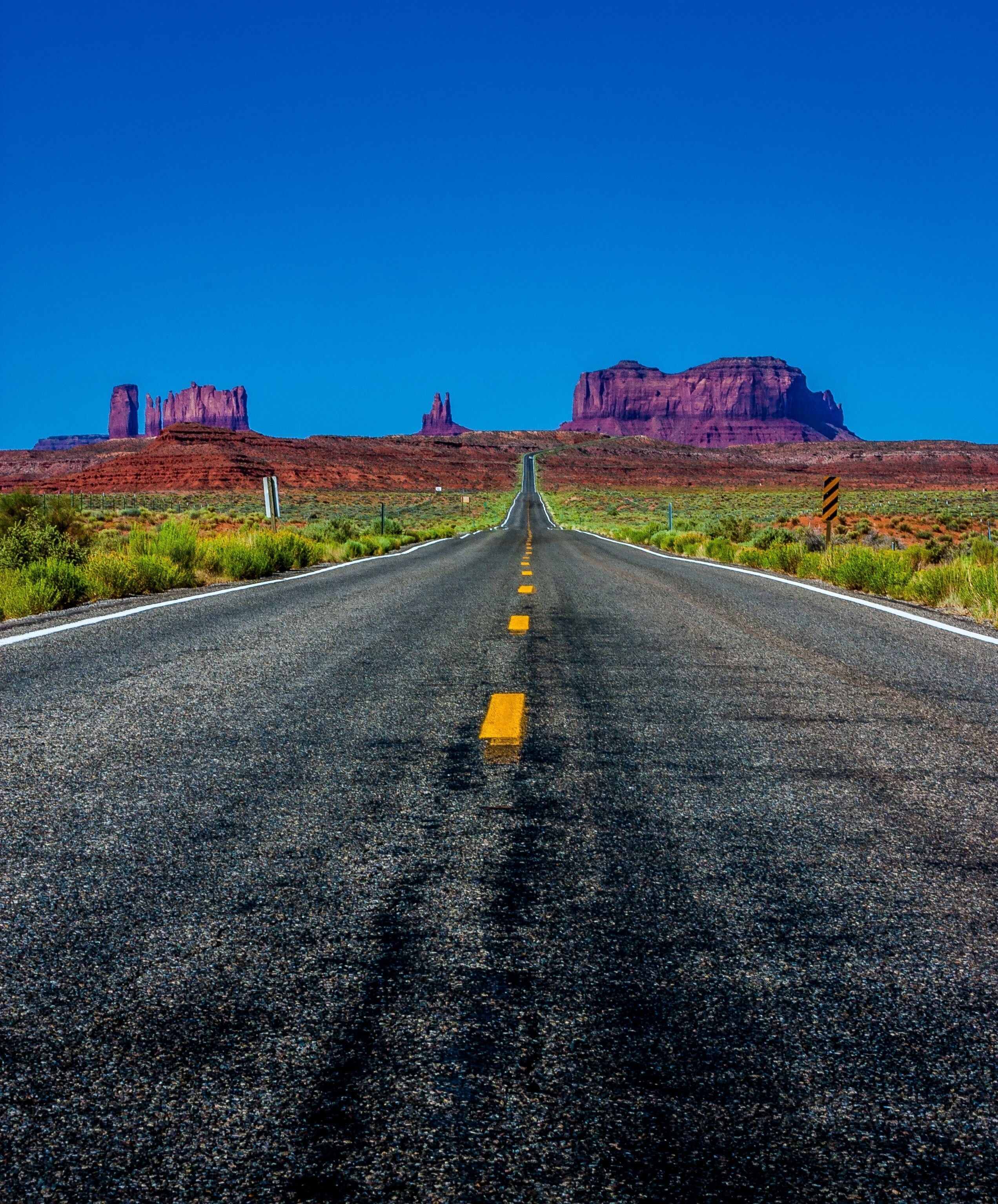 Before you arrive at Monument Valley from the North, stop on this straight piece of road and enjoy the view.  You can see the valley from quite far away, in fact all the way back at Goosenecks National Park. This classic road shot gives you the sense of wanting to just get out and do that road trip. #OnTheRoad