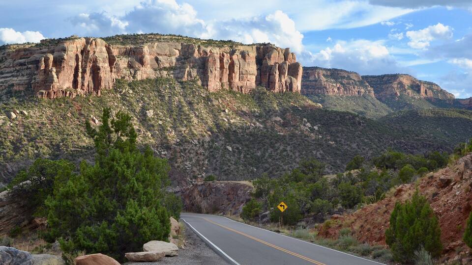 Colorado National Monument road. Scenic drive towards the massive red sandstone and granite plateaus.