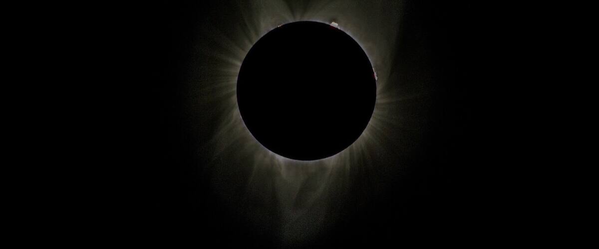 A solar eclipse with a dark center and bright corona.