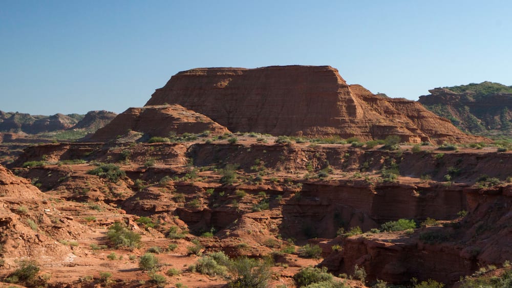 Prehistoric cliffs in Sierra de las Quijadas National Park, San Luis, Argentina. Arid desert landscape. Red sandstone canyon and valley.