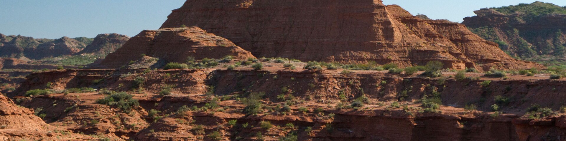Prehistoric cliffs in Sierra de las Quijadas National Park, San Luis, Argentina. Arid desert landscape. Red sandstone canyon and valley.