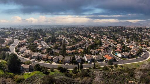 View of north valley neighborhood homes with storm clouds in the Porter Ranch community of Los Angeles, California.