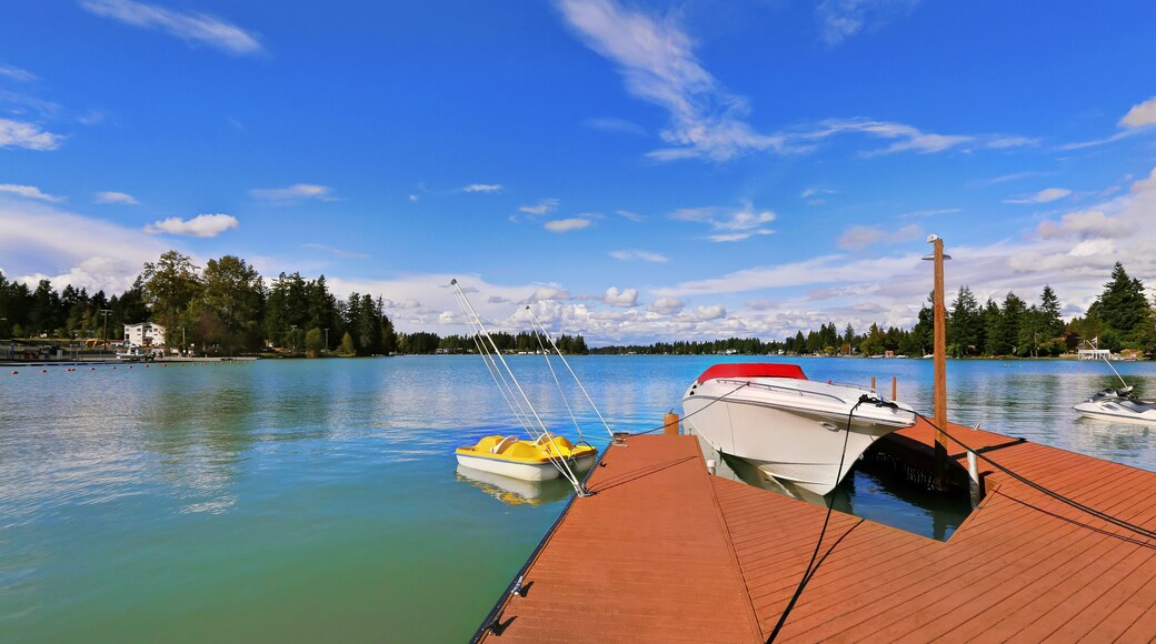 View of wooden pier with blue lake Tapps ,sky background