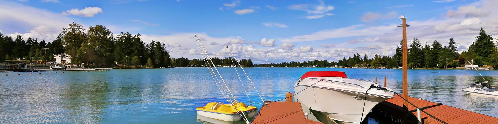 View of wooden pier with blue lake Tapps ,sky background