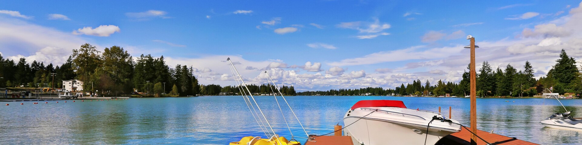 View of wooden pier with blue lake Tapps ,sky background