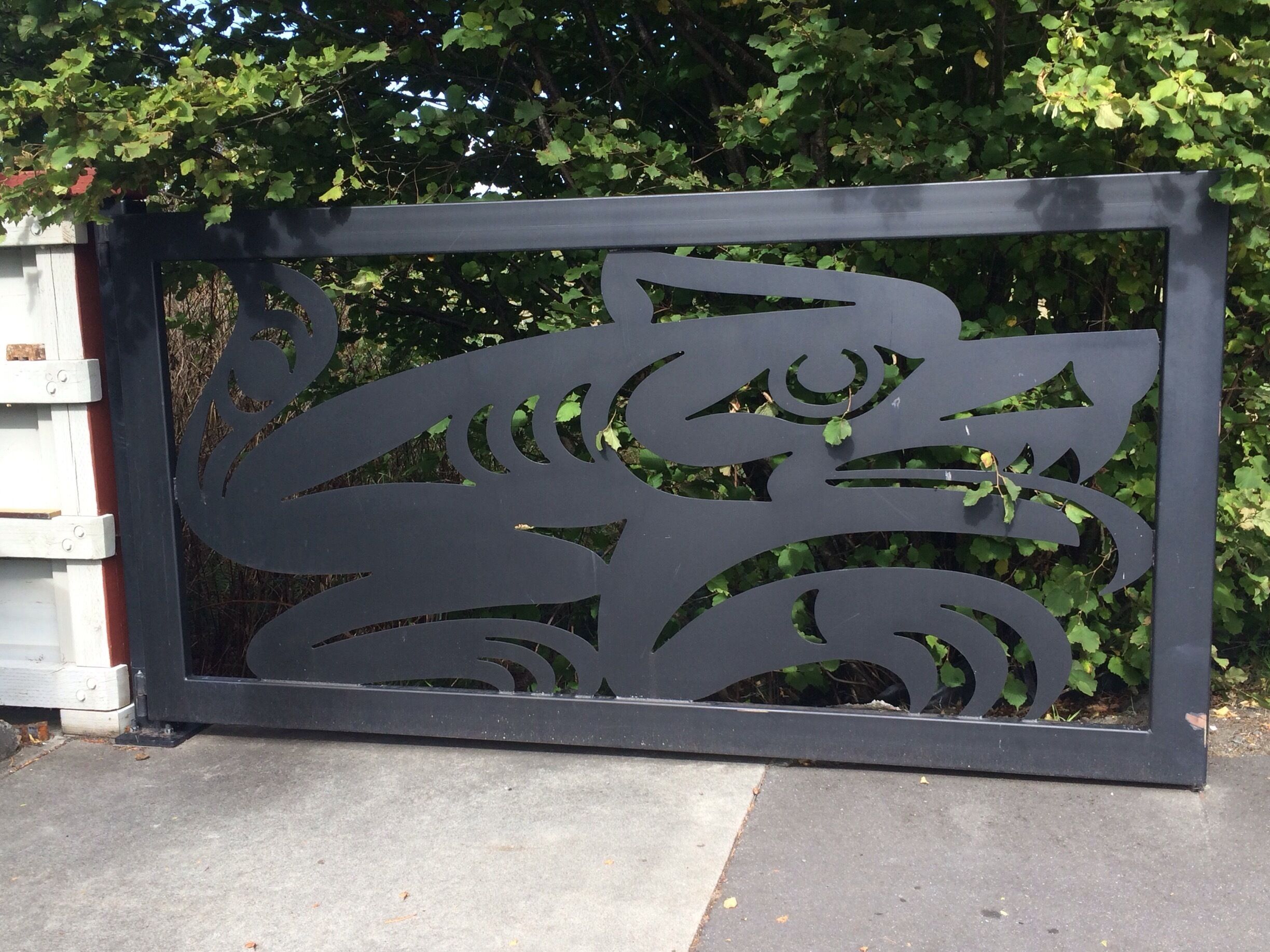 A black metal gate with a decorative cut-out design.