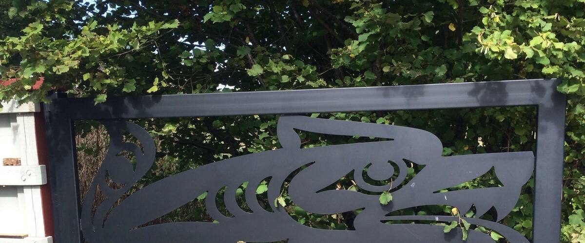 A black metal gate with a decorative cut-out design.