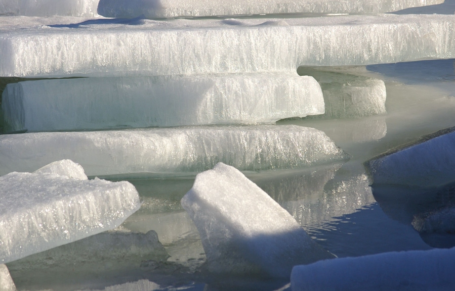 During a spring thaw the ice started to break up on the Detroit river. The river has a strong current which caused this pile up as the pieces started to shift. I liked the sun on the ice, the texture of the ice and the reflections.