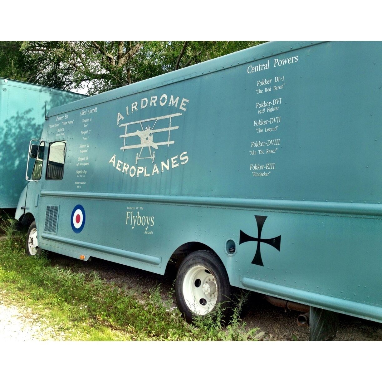 A vintage aircraft transport vehicle with 'Airdrome Aeroplanes' and 'Central Powers' written on it.