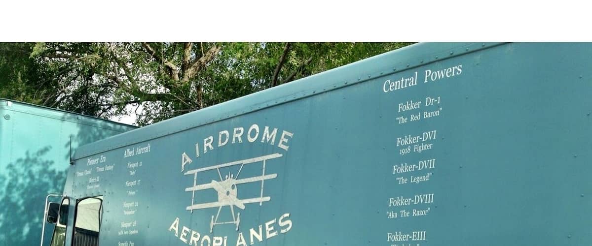 A vintage aircraft transport vehicle with 'Airdrome Aeroplanes' and 'Central Powers' written on it.