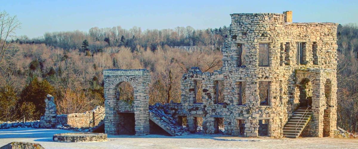 A stone building with a 'PRIVATE PROPERTY KEEP OUT' sign in front.
