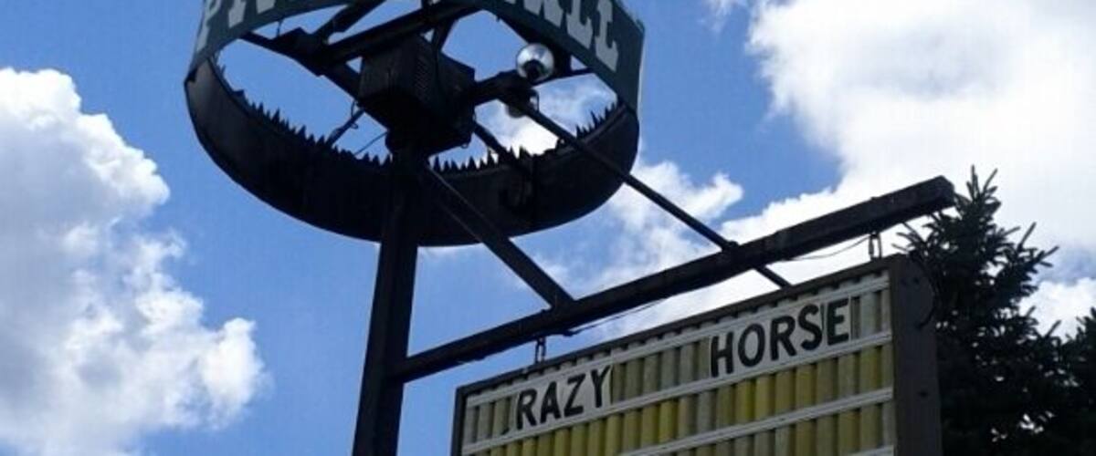 A sign for "Razy Horse" with a horse statue.