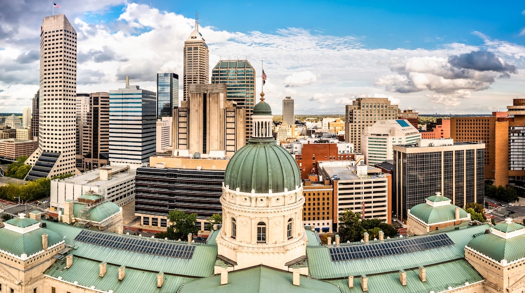 A cityscape with a prominent dome structure, modern skyscrapers, and a clear sky.