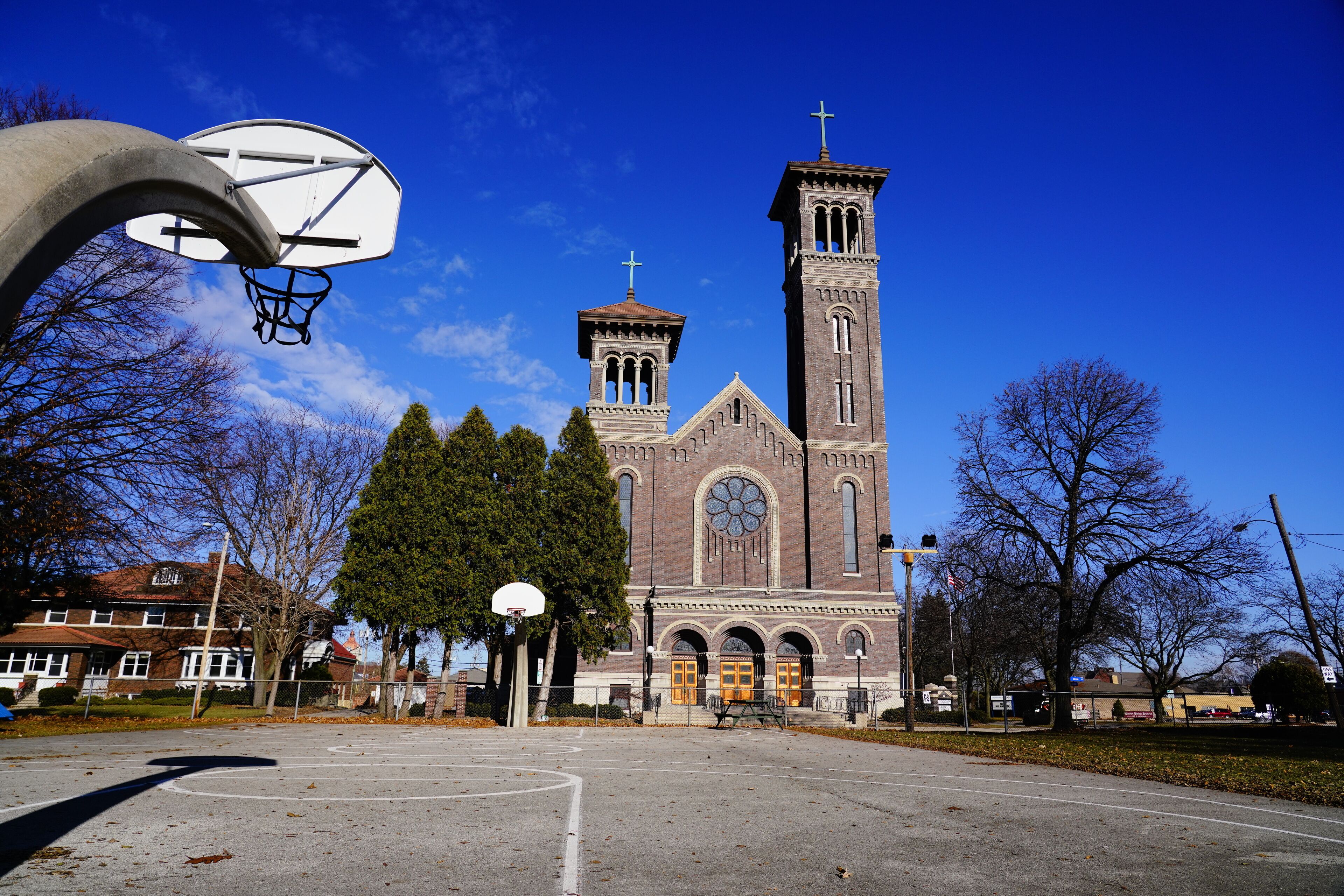 A basketball court with a church in the background.