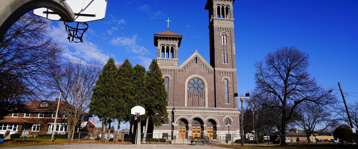 A basketball court with a church in the background.