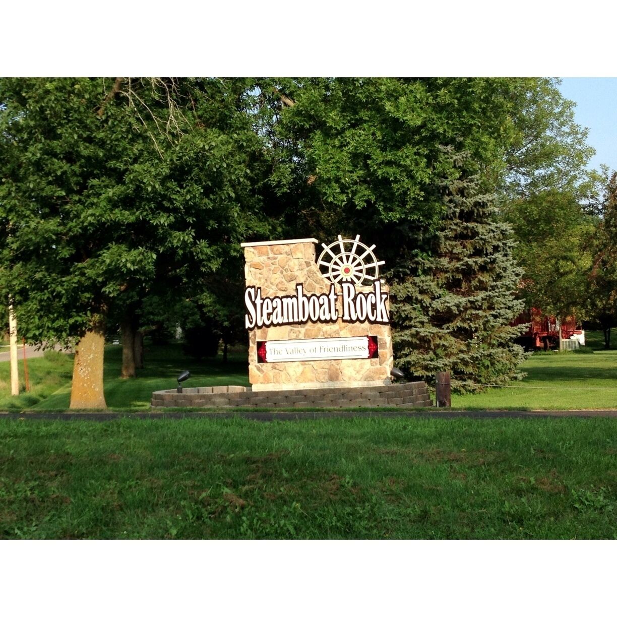 A sign for Steamboat Rock with a ship wheel logo and the text "The Valley of Friendliness".