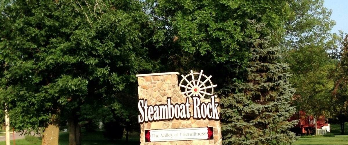 A sign for Steamboat Rock with a ship wheel logo and the text "The Valley of Friendliness".