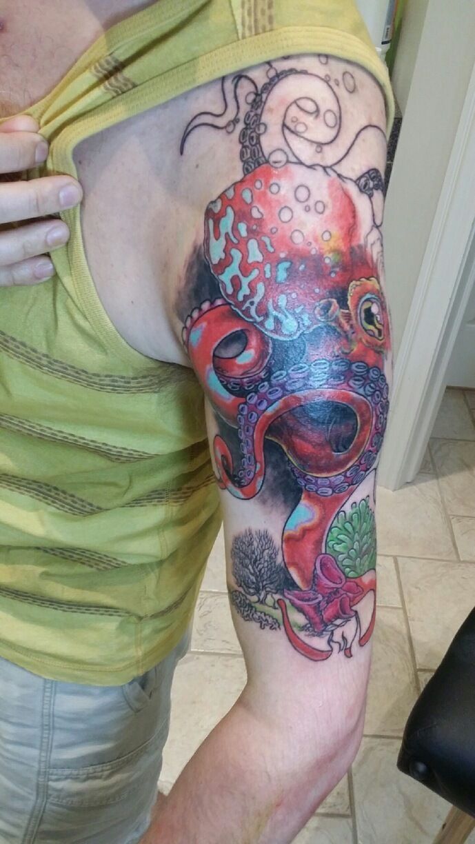 A person with a tattoo of an octopus on their upper arm.