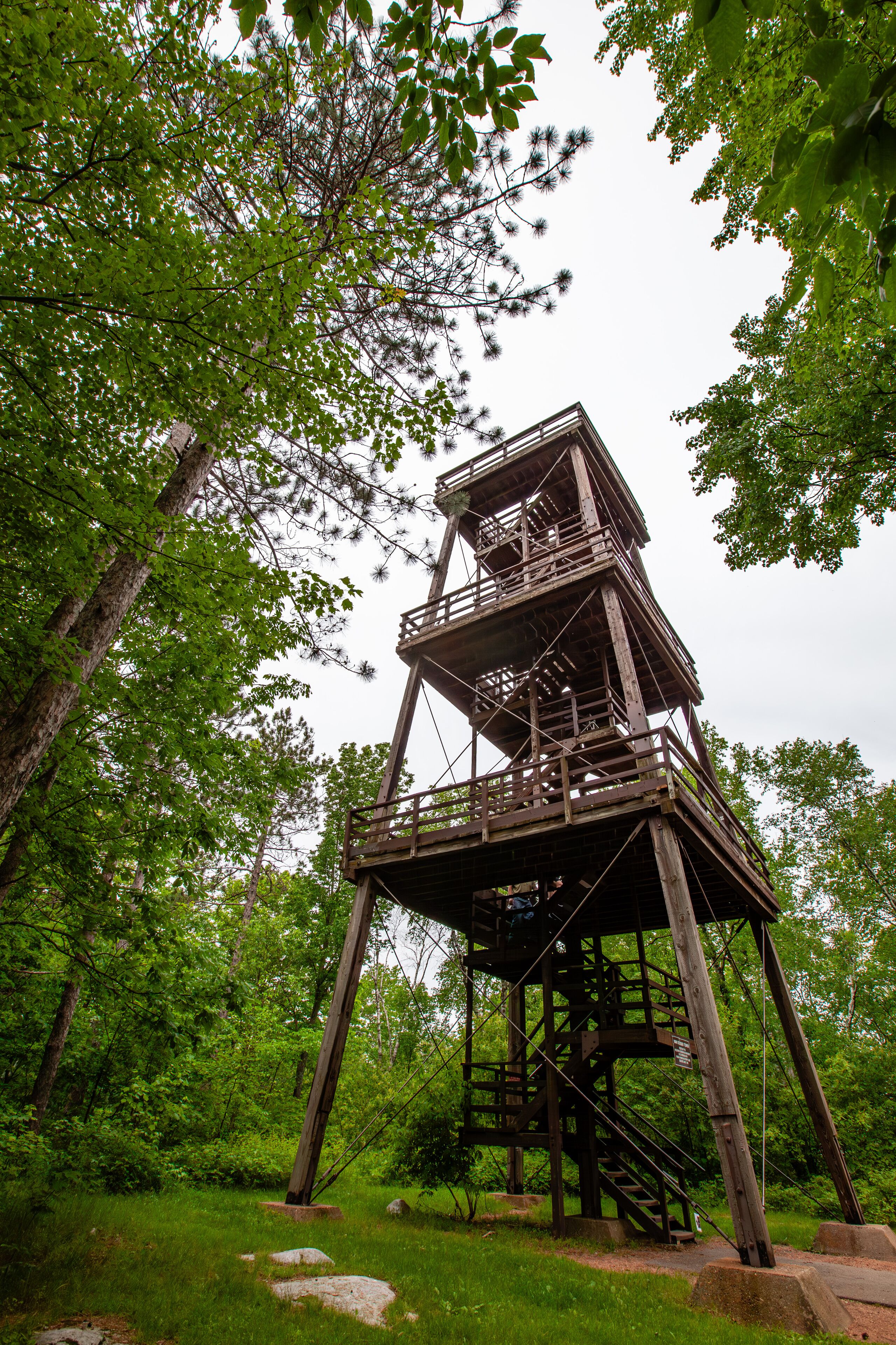 A wooden observation tower in a forest.