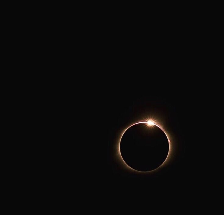 A solar eclipse with a bright corona around the sun.