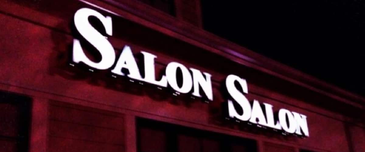 A building with illuminated signage reading "Salon Salon."