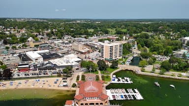A coastal town with a marina, beach, and historic buildings.