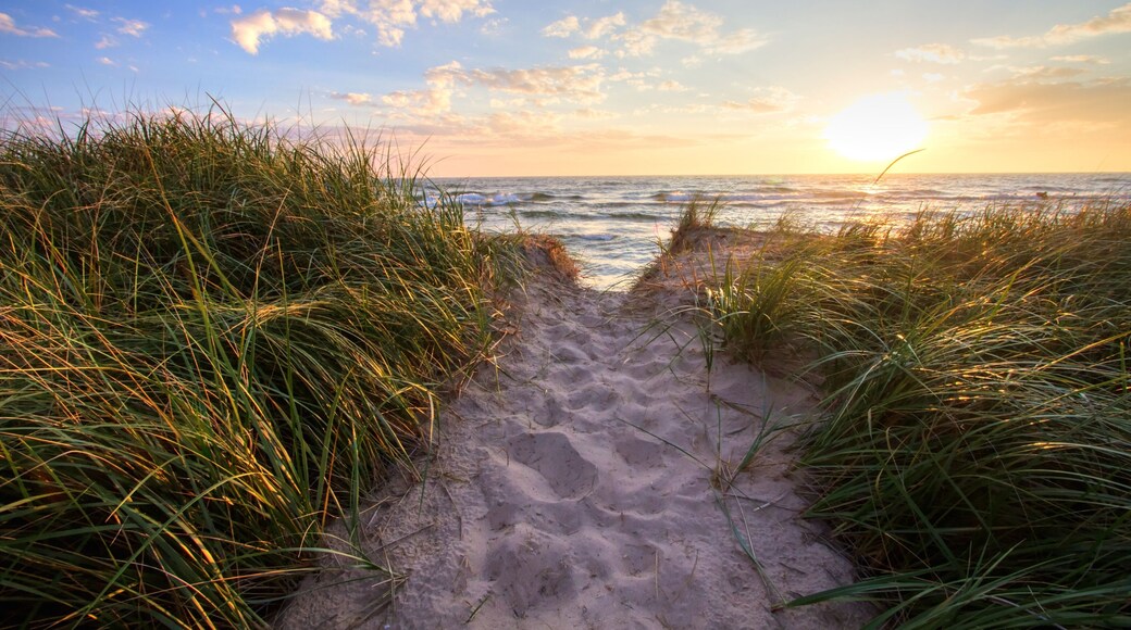 Path To A Summer Sunset Beach. Sandy beach trail leads to a sunny summer horizon over the open waters of Lake Michigan. Hoffmaster State Park. Muskegon, Michigan.