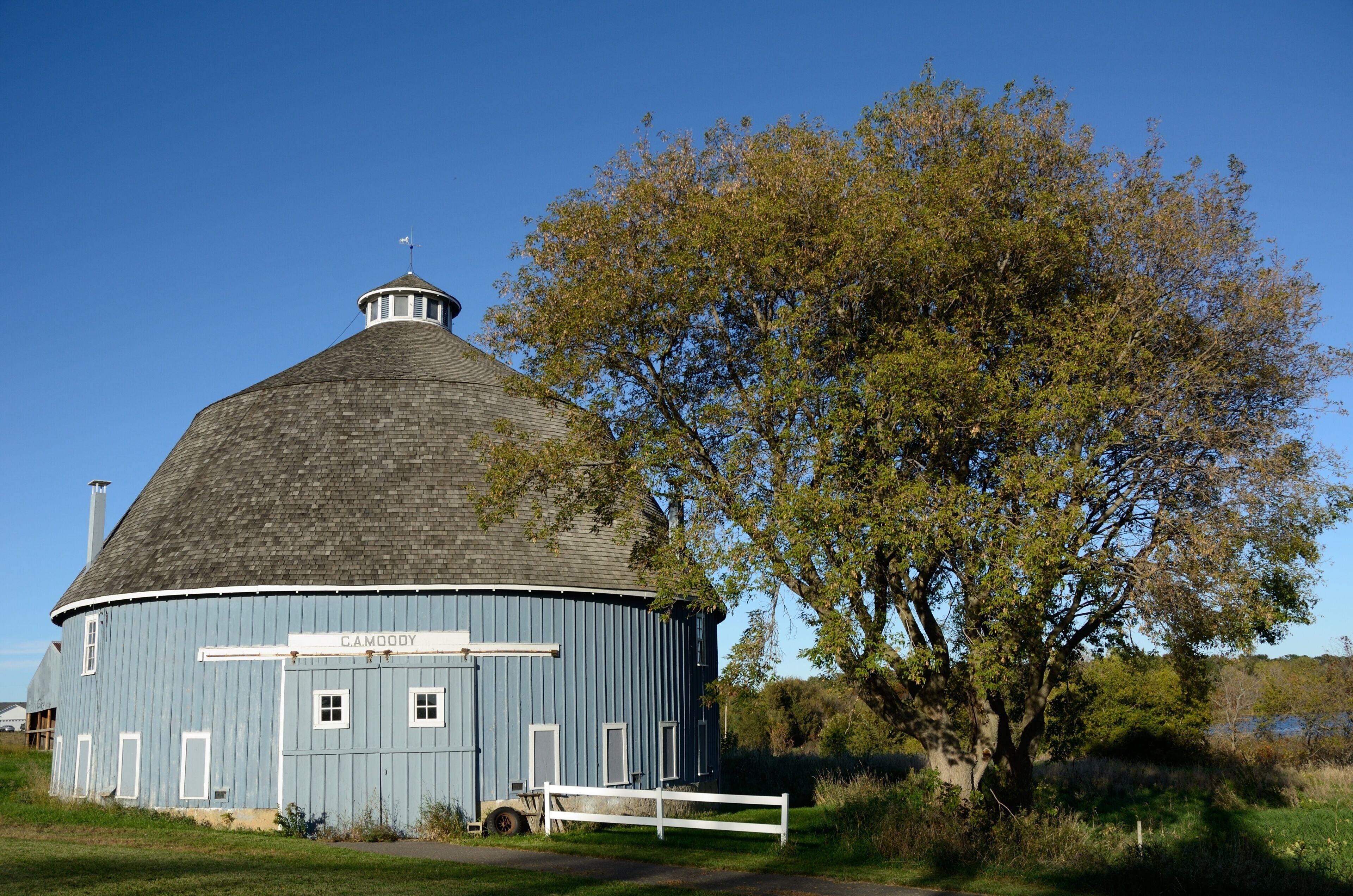 A blue building with a dome roof and a sign reading 'CAMODY.'