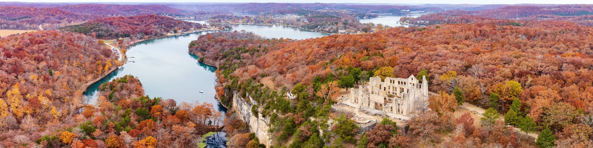 Aerial view of the fall color of Lake Ozark and the castle ruins