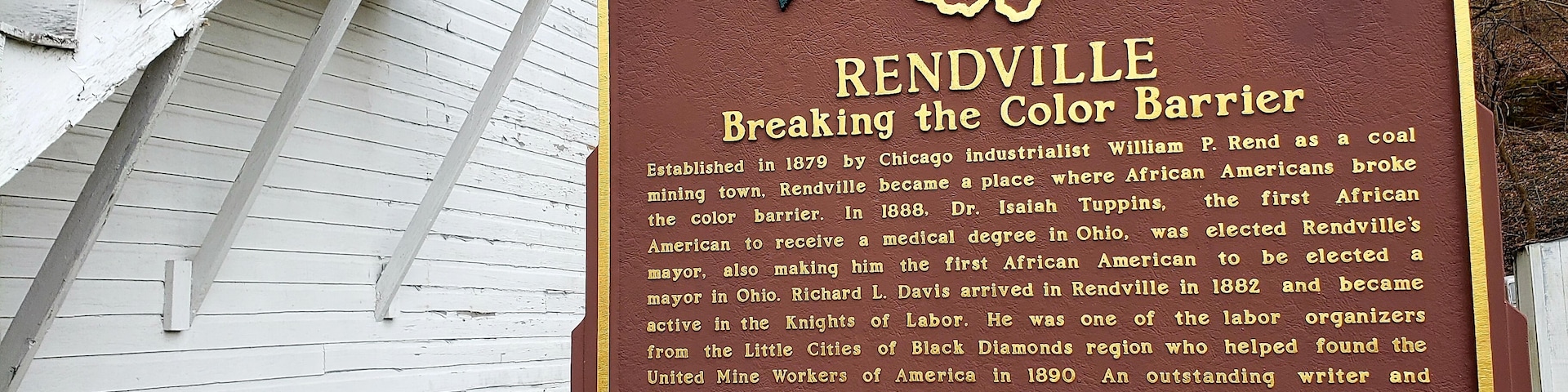 A historical marker sign with text about Reddville's role in breaking the color barrier.