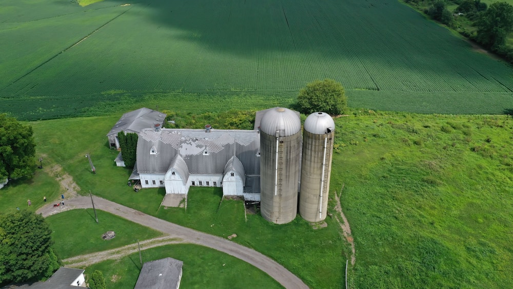 Aerial Amish farm barn silo Mesopotamia Ohio. Settled late 1700's as pioneer religious settlement. Old Amish Mennonite town. Rural order. Farming landscape. Old Amish Mennonite settlement.