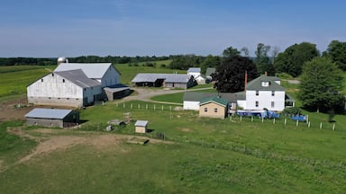 Aerial Ohio Amish countryside farm barn laundry. Settled late 1700's as pioneer religious settlement. Amish Mennonite town. Rural order. Farming landscape. Old Amish Mennonite settlement.