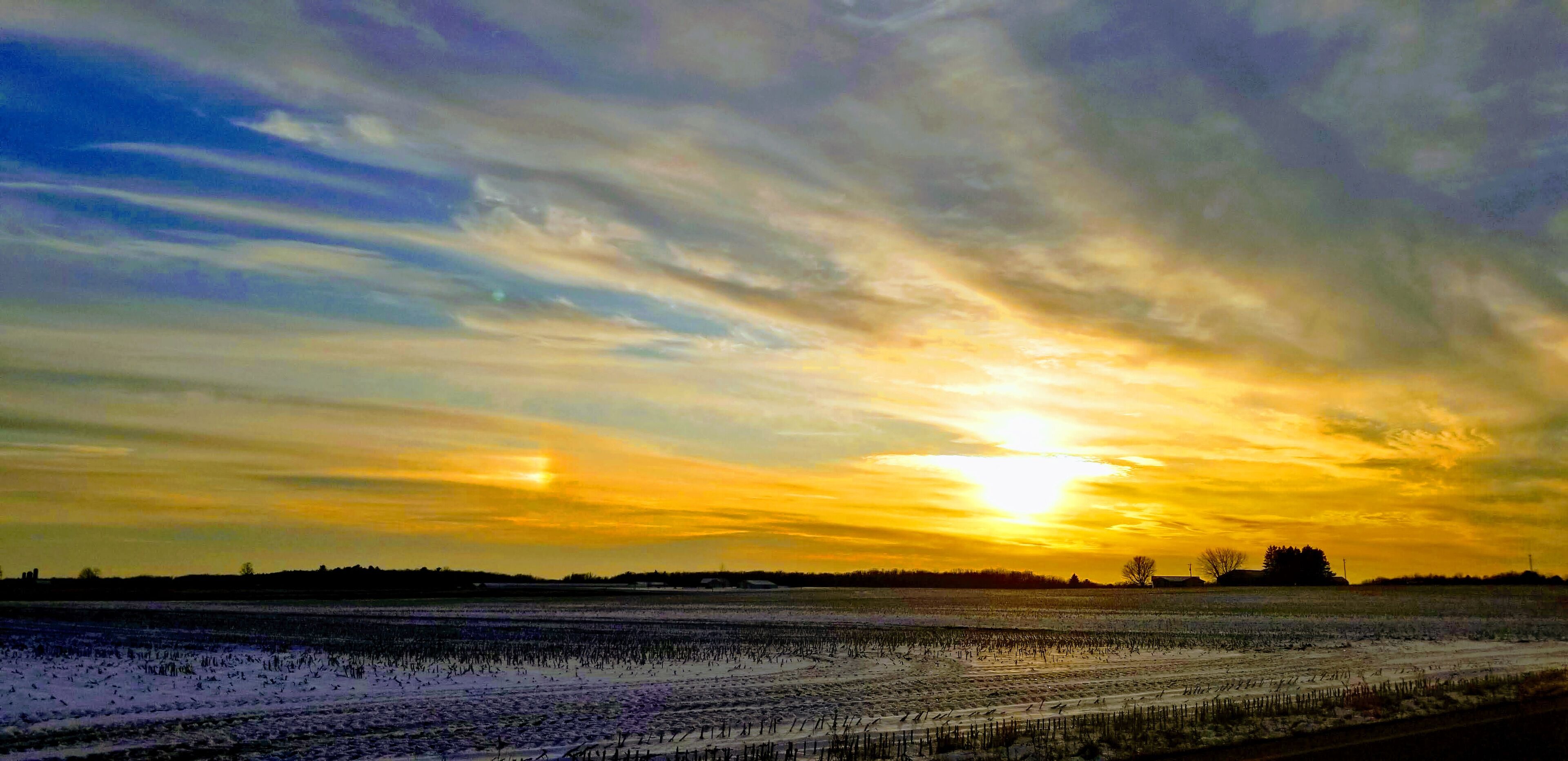 Sunset last evening. There is a segment of  sundog to the left of the sun.
