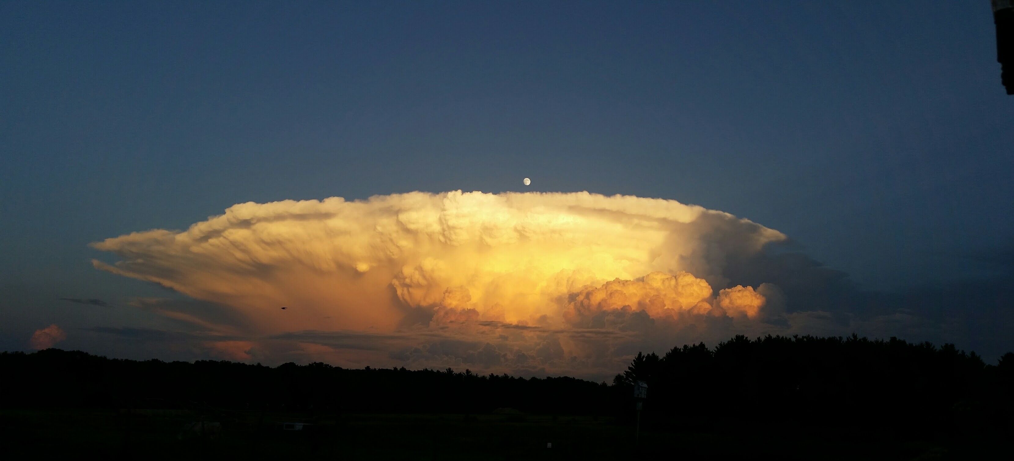 Taken from #Mybackyard in central Wisconsin  looking to the southeast. My first thought was I hoped Chicago was okay! The moon is visible just over the cloud, center.