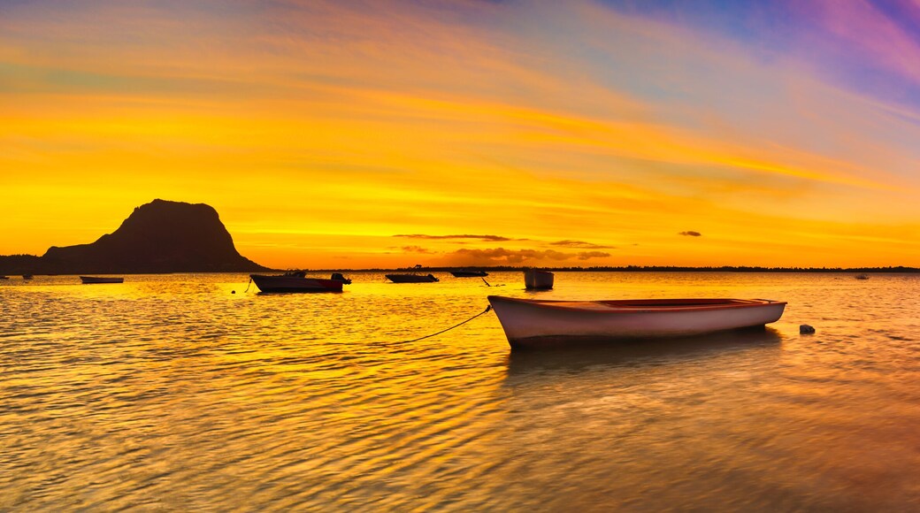 Fishing boat at sunset time. Le Morn Brabant on background. Pano