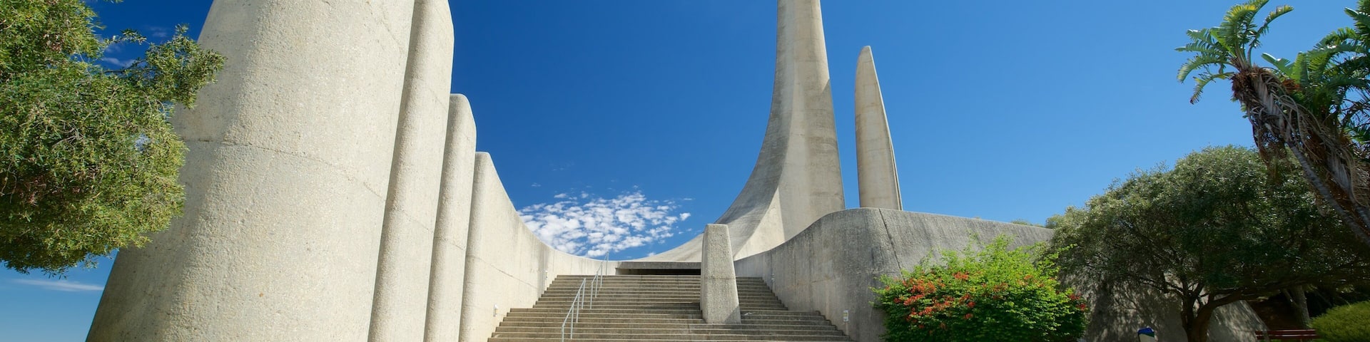 A modern architectural structure with tall, slender towers and a staircase leading up to a platform.