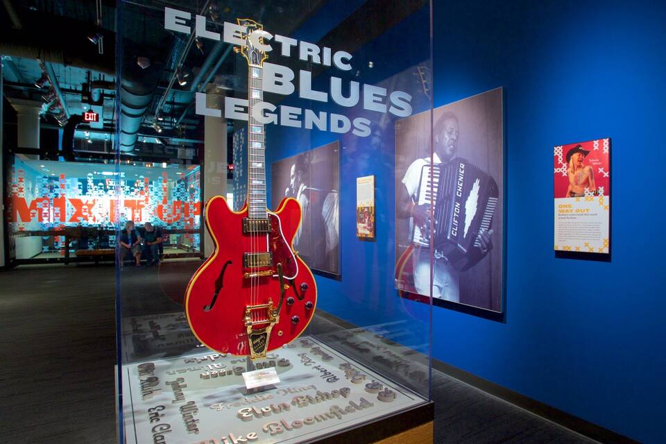 An exhibit of electric blues legends with guitars and memorabilia.