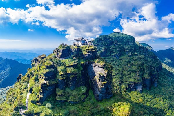 A temple on a mountain peak with a clear sky.