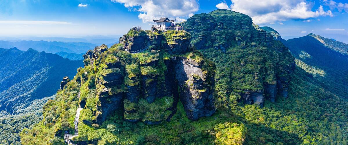 A temple on a mountain peak with a clear sky.