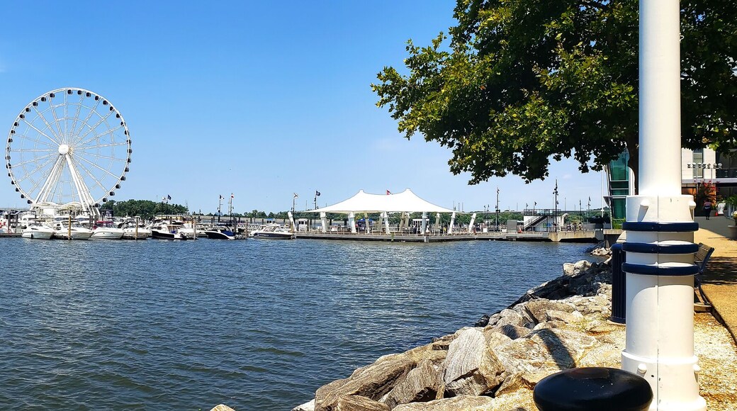 View to Ferris wheel and yacht marina pier on the Potomac River in National Harbor, Maryland.