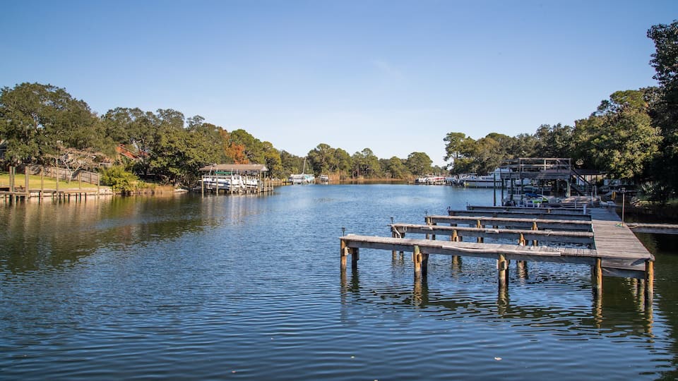 A calm lake with wooden docks and boats.