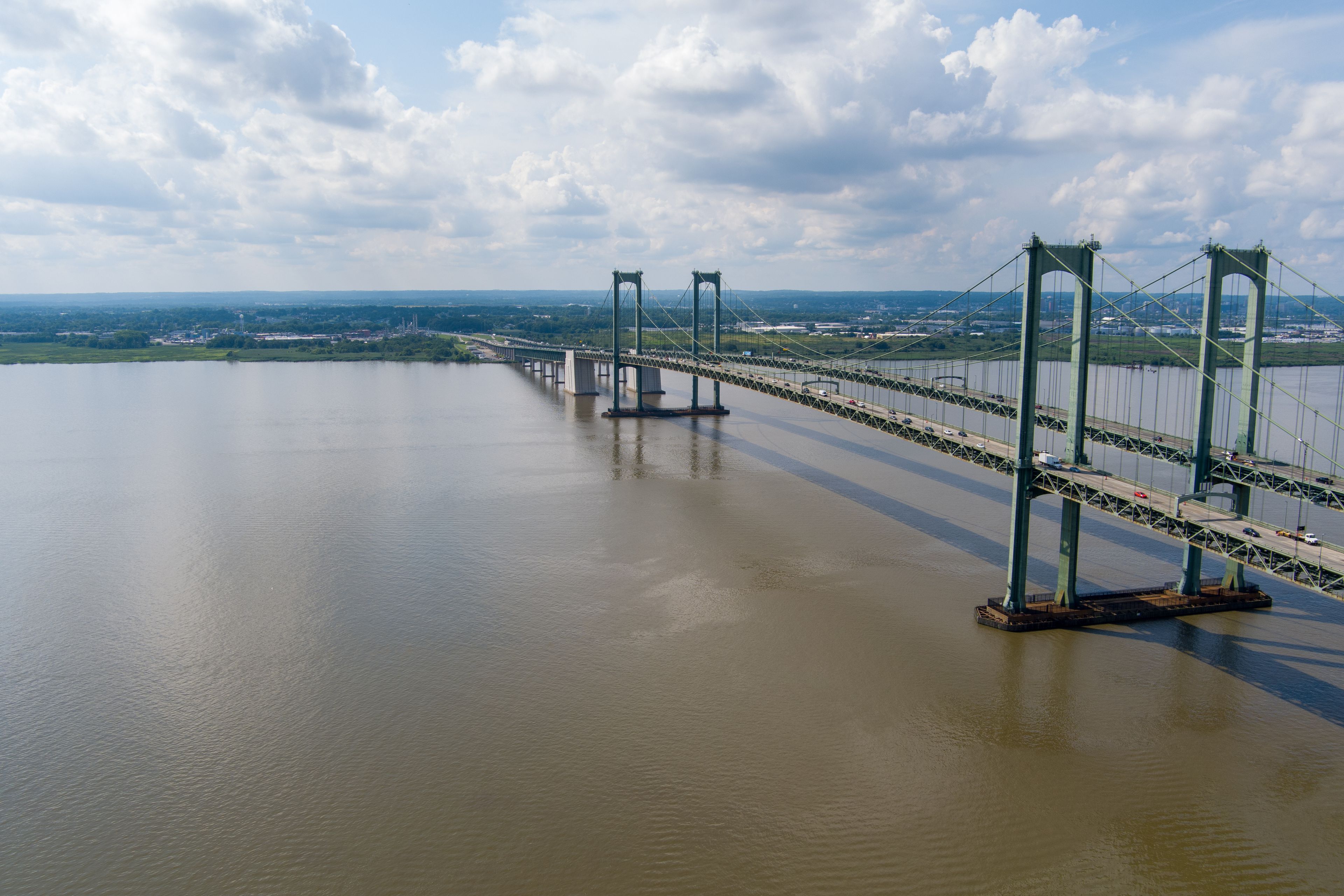A large suspension bridge spanning a wide river.