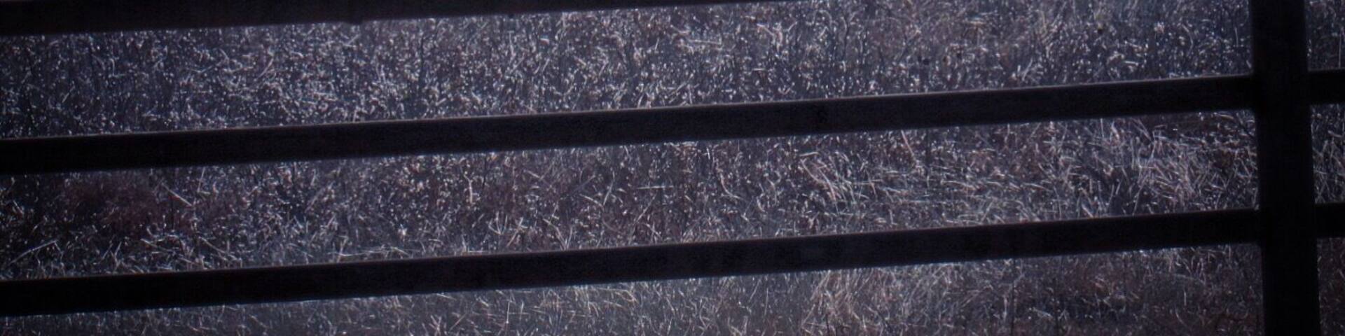 The terrain slopes down to Quartz Mountain State Park, about 30 miles southeast of this interesting fence art on Highway 55 east of Carter, Oklahoma.