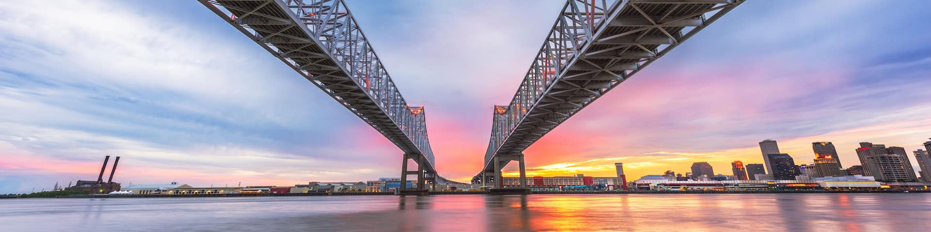 A bridge with a sunset in the background.