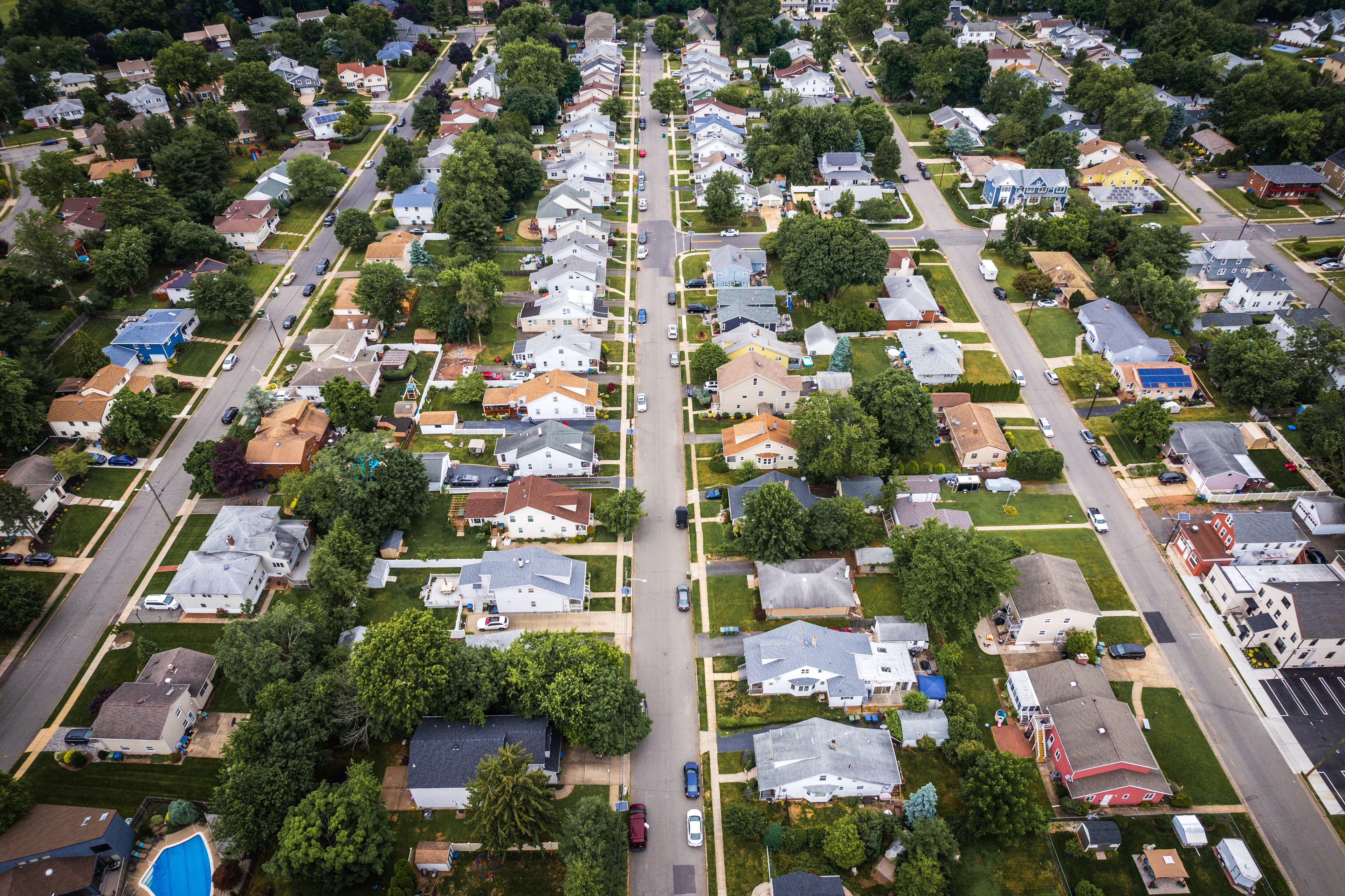 An aerial view of a residential neighborhood with houses, streets, and green spaces.