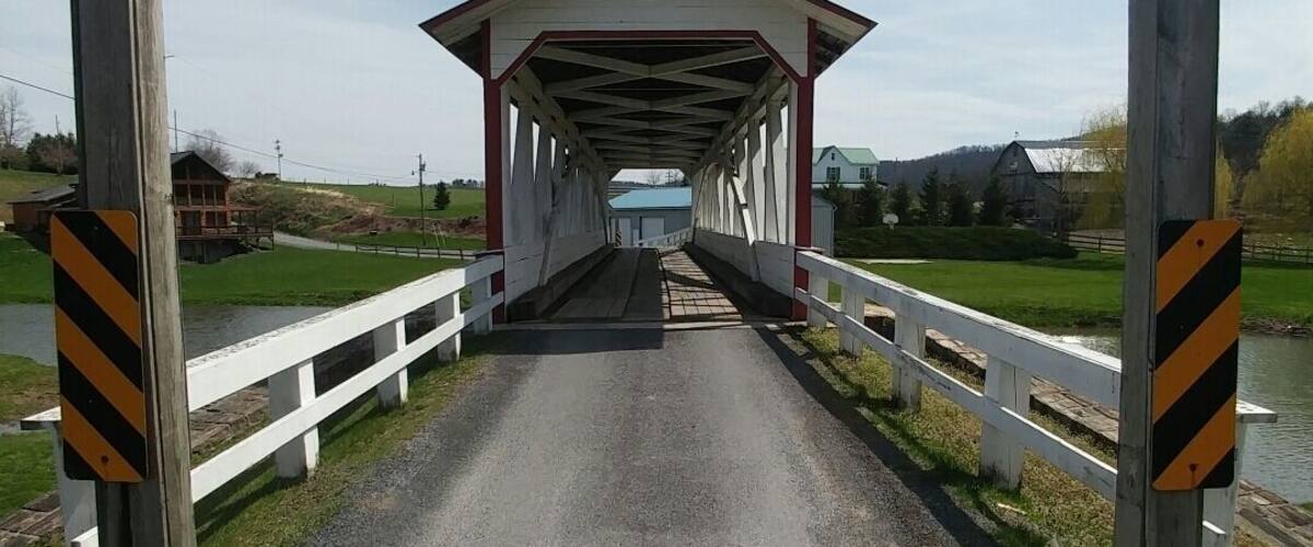 A covered bridge with a clearance sign indicating 8 ft 11 in.